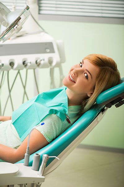 woman smiling during her visit to Pinnacle Dental Group