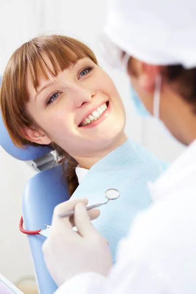 woman smiling during her visit to Pinnacle Dental Group