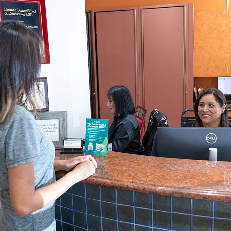 Patient at front desk inquiring about dental financing